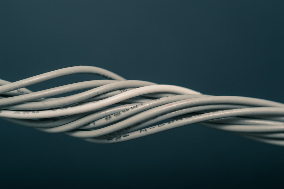 A bundle of computer cables and power leads gathered together before being tidied away