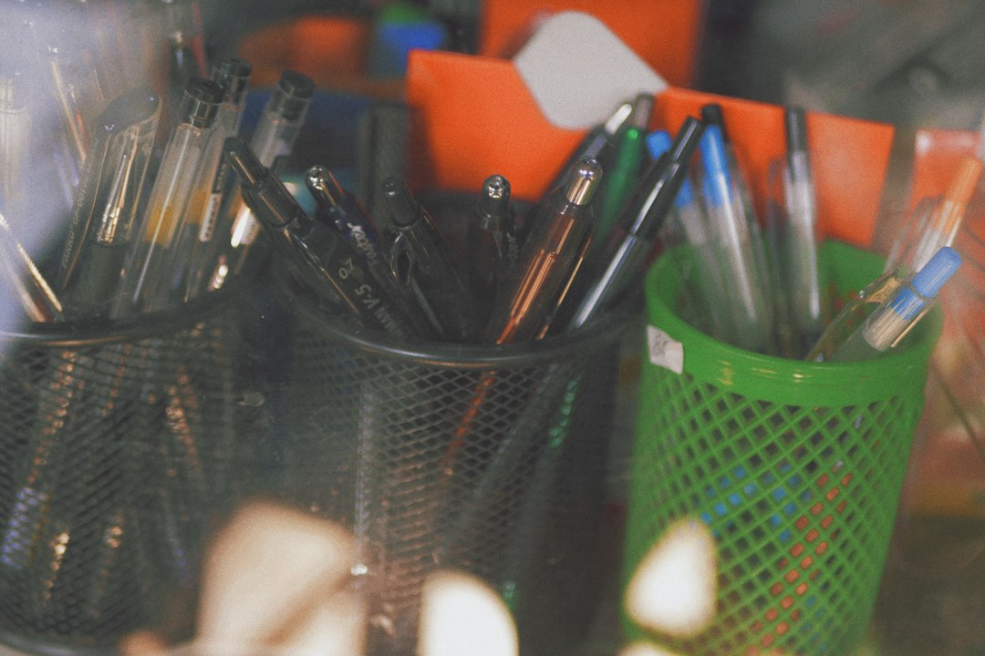 A pack of ballpoint pens on a desk surface